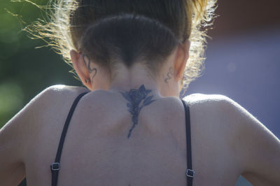 Rear view of young woman looking away