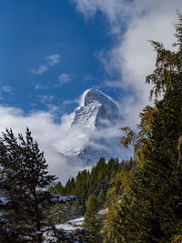 Low angle view of snowcapped mountain against sky