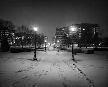 View of snow covered street at night