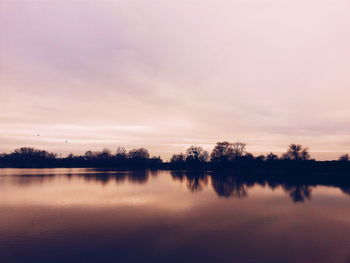 Scenic view of lake at sunset
