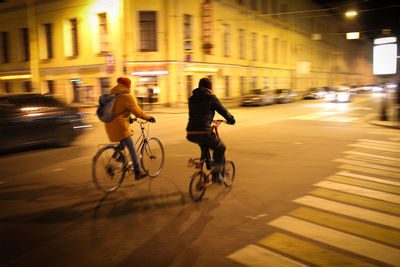 People riding bicycle on city street