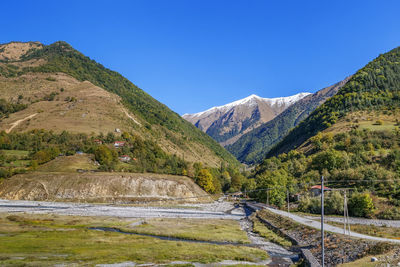 Scenic view of mountains against clear blue sky