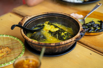 Close-up of claypot fish food on table