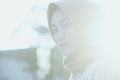 Side view of woman wearing hijab during sunset