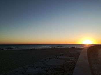 Scenic view of sea against clear sky during sunset