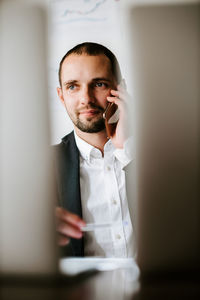 Businesswoman talking on phone at office