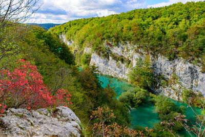 Scenic view of waterfall against sky