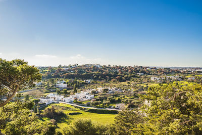 High angle view of townscape against clear blue sky