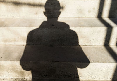 Shadow of person on footpath