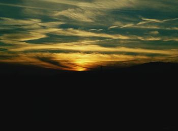 Silhouette of landscape against dramatic sky