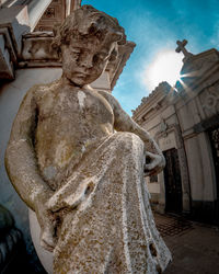 Low angle view of angel statue against sky