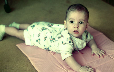 Portrait of cute girl lying on bed