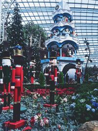 Statue of red flowers against built structure