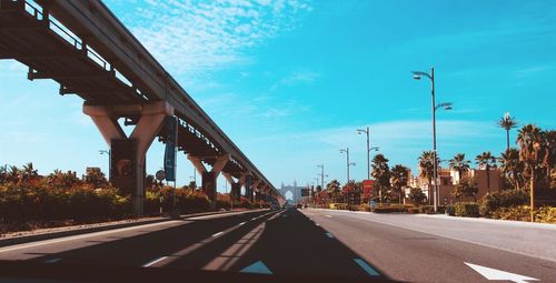 Road by bridge against sky in city