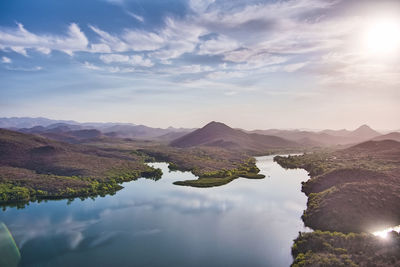 Scenic view of lake and mountains against sky