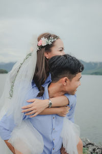 Couple standing on shore