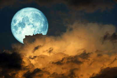 Low angle view of moon in sky at night