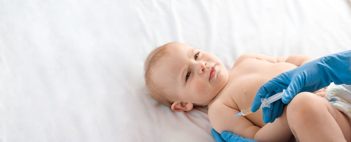 Doctor vaccinating newborn baby in clinic. little baby get an injection. vaccine for infant child. 