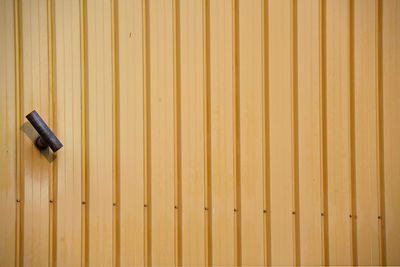 Low angle view of metal on wooden wall