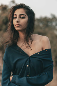 Portrait of a beautiful young woman standing outdoors