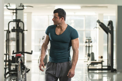 Muscular man standing in gym