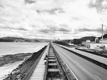 View of railroad tracks against cloudy sky