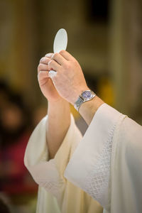 Cropped hands of priest performing ritual