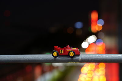 Close-up of toy car on road at night