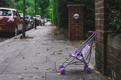 Empty footpath by street in city