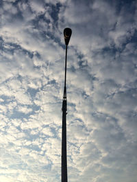 Low angle view of street light against cloudy sky