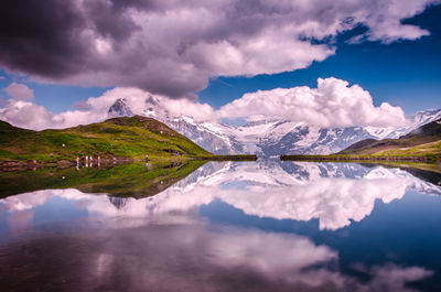 Scenic view of lake and mountains against sky at sunset