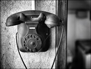 Old-fashioned telephone mounted on wall