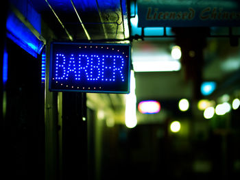 Close-up of road sign at night