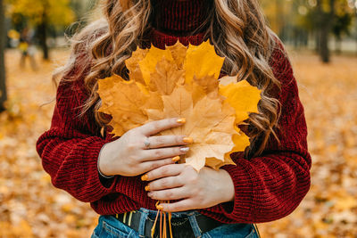 Faceless portrait of woman with maple leaves. activities for happy fall, improve yourself, ways to