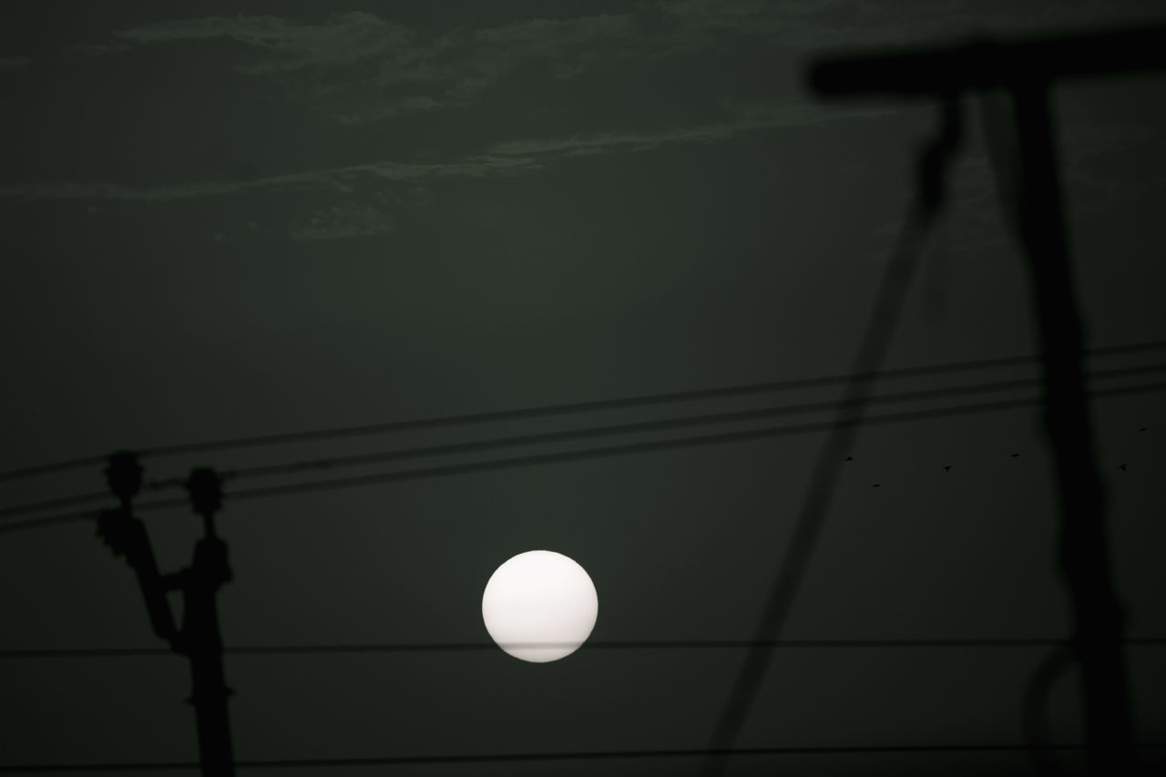 LOW ANGLE VIEW OF SILHOUETTE LIGHTS AGAINST SKY AT DUSK