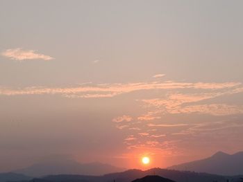 Scenic view of silhouette mountains against sky during sunset