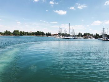 Sailboats in sea against sky