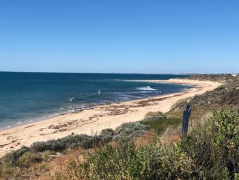 Scenic view of sea against clear blue sky