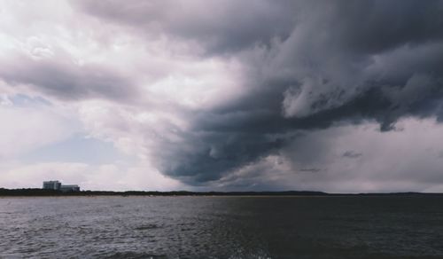 Scenic view of sea against storm clouds