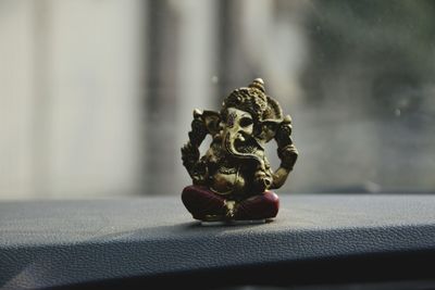 Ganesha figurine on car dashboard