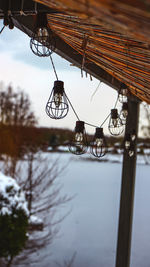 Low angle view of chain hanging over lake against sky