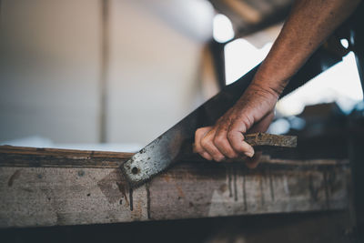 Cropped hand of man working at home