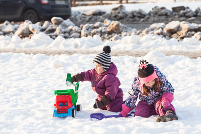 Rear view of people in snow