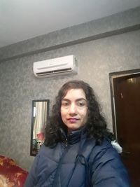 Portrait of smiling woman at home