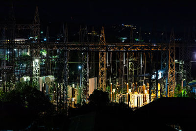 Illuminated bridge and buildings in city at night