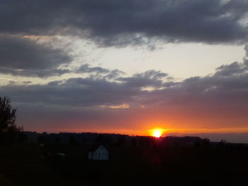 Silhouette buildings against sky during sunset