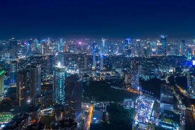 High angle view of illuminated buildings in city at night