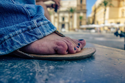 Low section of woman wearing shoes