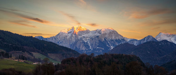 Scenic view of snowcapped mountains against sky during sunset