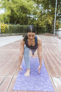 Women making yoga on the park